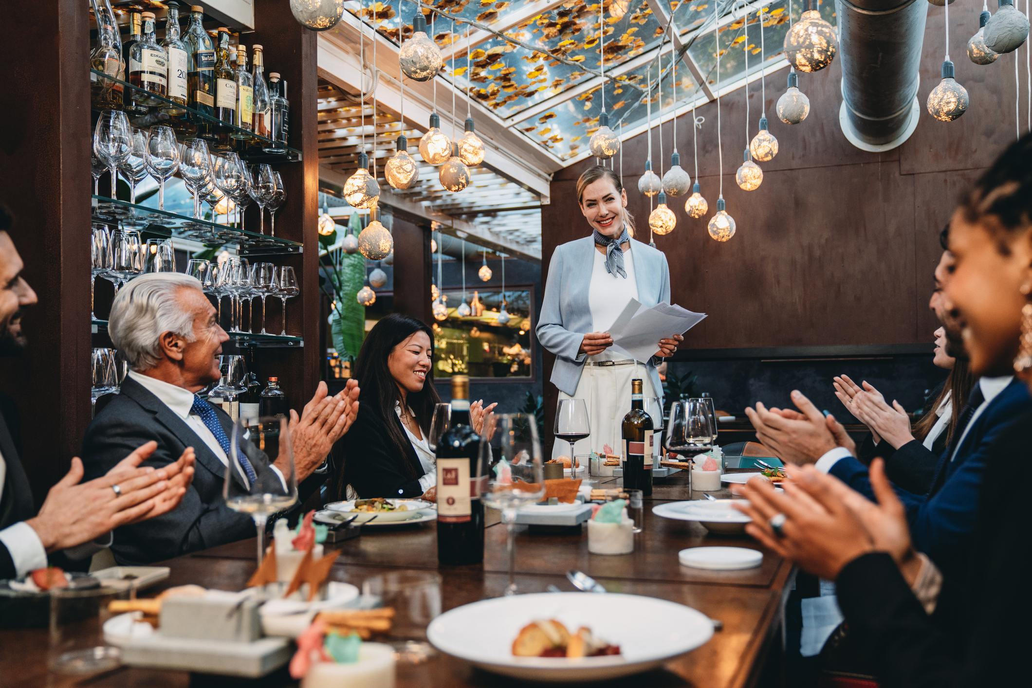 Business meeting at the restaurant. Business people are brainstorming during a strategy presentation in an high-end luxury restaurant.